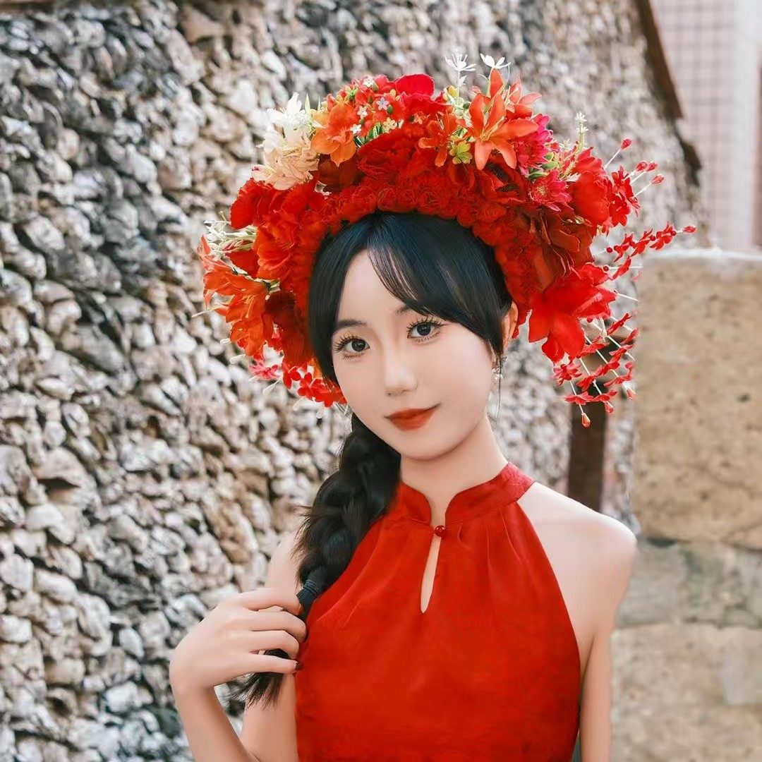 Nicole wearing a red flower crown and red dress